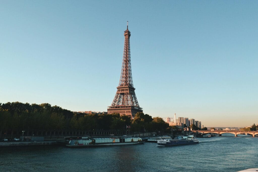 7 Best Places of Love with Great Love Stories Behind Them 3 Scenic view of the Eiffel Tower and Seine River at sunset, showcasing iconic Parisian architecture.
