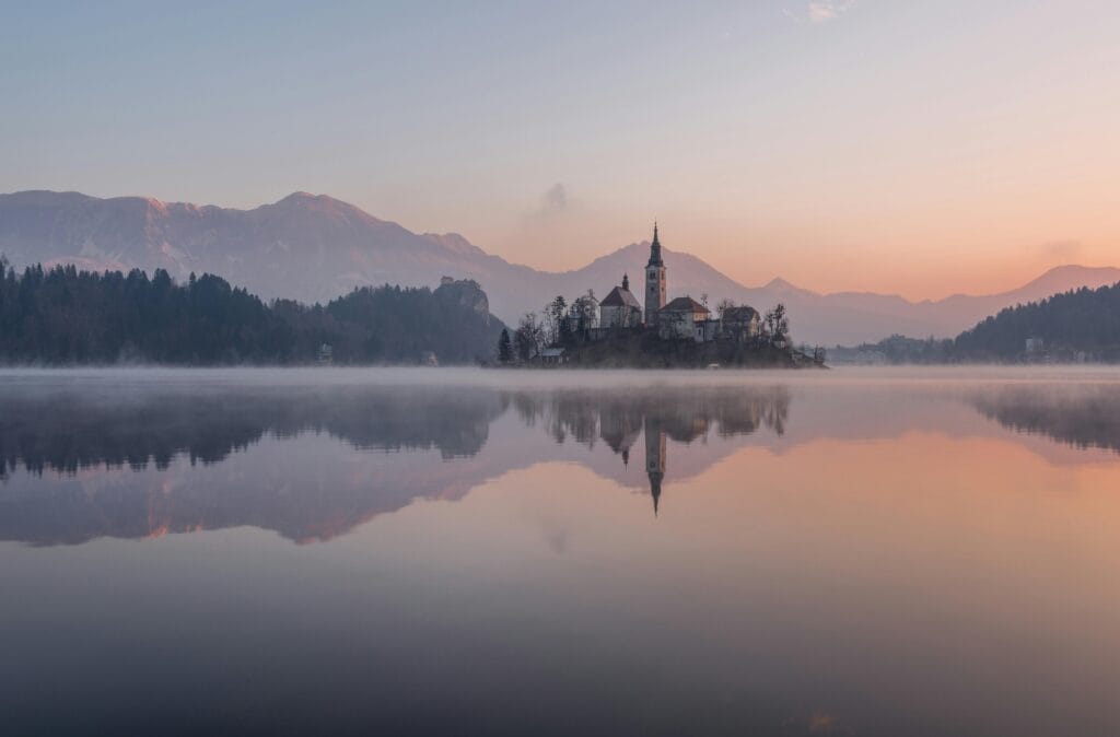 7 Best Places of Love with Great Love Stories Behind Them 5 Tranquil morning view of Lake Bled with misty reflections and church silhouette.